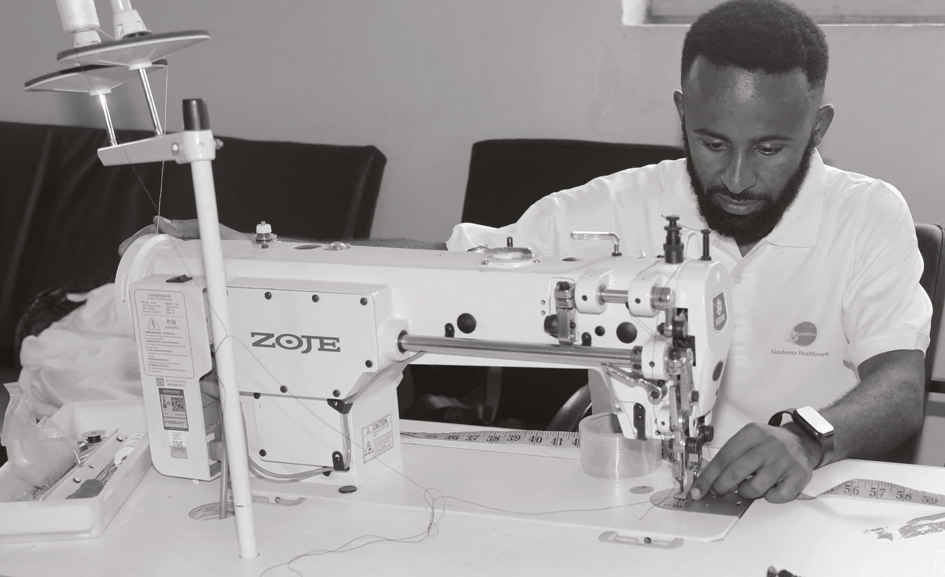 A Simbona technician sewing at an industrial machine